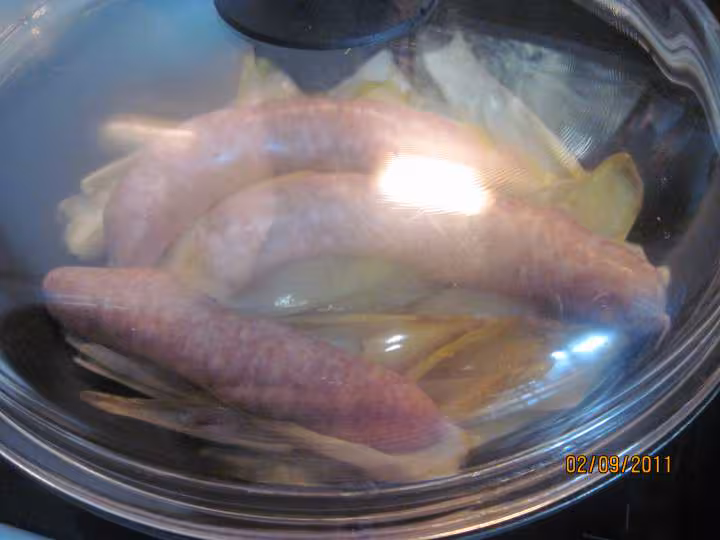 Saucisses de toulouse sur 1 lit d endives a la sauce tomates